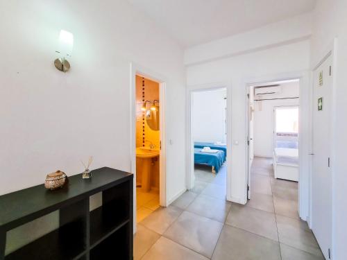 a living room with white walls and a black table at FLH Monte Gordo Summer Flat in Monte Gordo