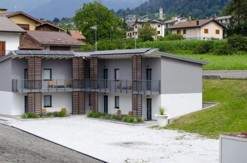 a house with a courtyard and a balcony at Hotel Alla Fonte in Arta Terme