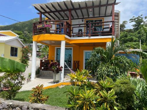 a house with a balcony on the side of it at Posada Ashanty in Providencia