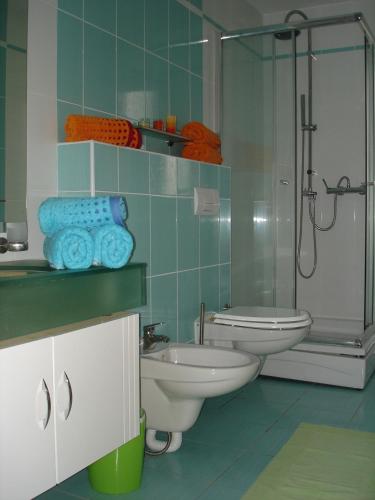 a bathroom with two toilets and a shower at Apartments Dalmatina in Zaton