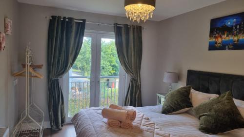 a bedroom with a bed with a stuffed animal on it at 2Bedroomed apartment on first floor with balcony in Kenmare