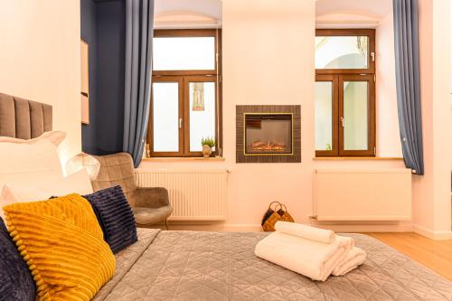 a living room with a bed and a fireplace at Uptown 46 in Braşov