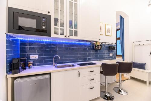 a kitchen with a sink and a microwave at Uptown 46 in Braşov