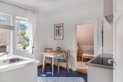 uma cozinha com uma mesa e uma sala de jantar em Fewo im Blauen Haus Dg em Garmisch-Partenkirchen