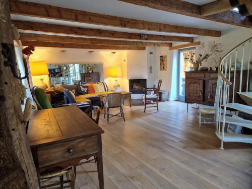 ein Wohnzimmer mit einem Sofa und einem Tisch in der Unterkunft La maison du vigneron in Auzon