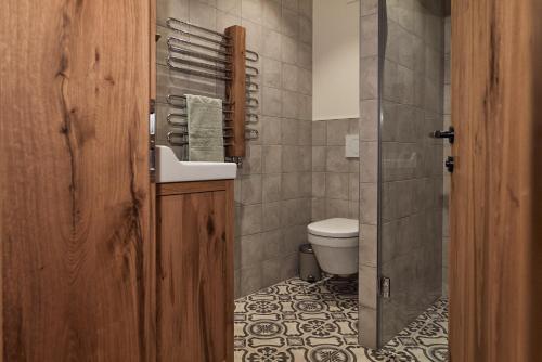a bathroom with a sink and a toilet at Berghaus Schröcken - Hotel Apartments Spa in Schröcken