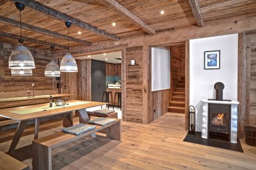 a living room with a table and a fireplace at Berghaus Schröcken - Hotel Apartments Spa in Schröcken