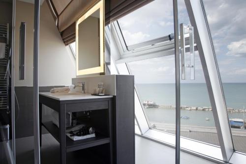 a bathroom with a sink and a large window at Ego Hotel in Ancona