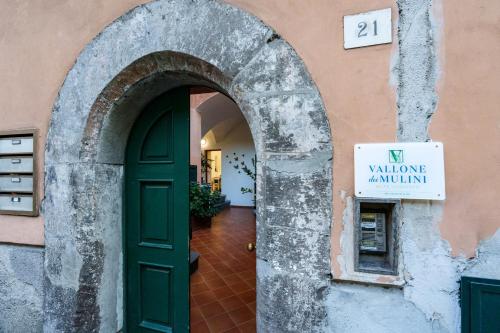 an entrance to a building with a green door at Vallone dei Mulini Suite in Sorrento
