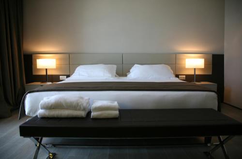 a bedroom with a large bed with two pillows at Ego Hotel in Ancona