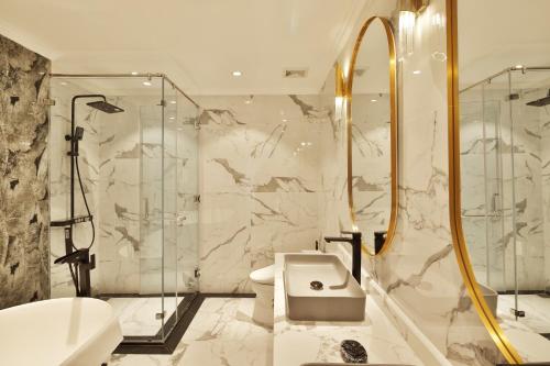 a bathroom with a toilet sink and a shower at Apartments by Vitrine in Hanoi