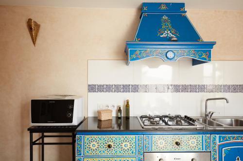 a kitchen with a blue and white stove top oven at Riad Ocean View - Entire Accommodation in Rabat