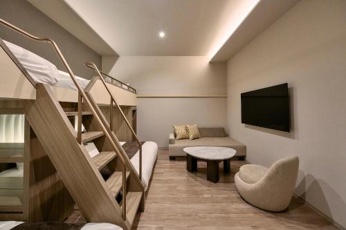 a small room with a bunk bed and a couch at fav HIROSHIMA STADIUM in Hiroshima