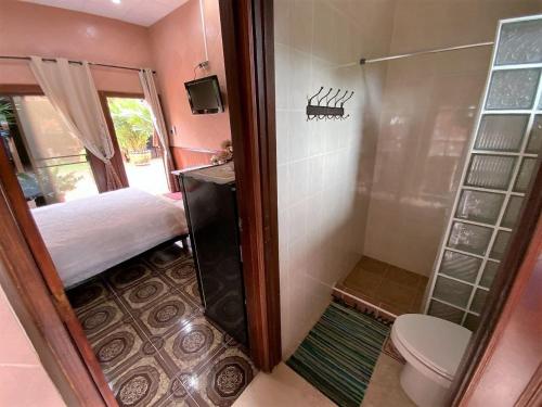 a small bathroom with a toilet and a shower at Magadan Residence in Pattaya South