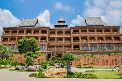 a large building with a garden in front of it at Santhiya Koh Chang Resort in Ko Chang