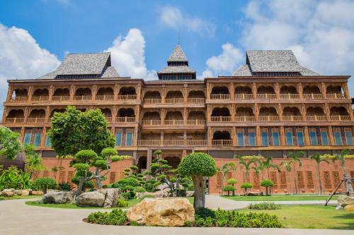 a large building with a garden in front of it at Santhiya Tree Koh Chang Resort in Ko Chang