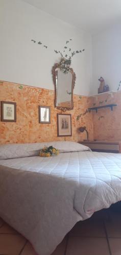 a bedroom with a large bed with a mirror at La Vecchia Quercia in Pergine Valdarno