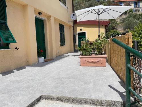 patio con ombrellone e piante in vaso di Cà di GIACO a Moneglia