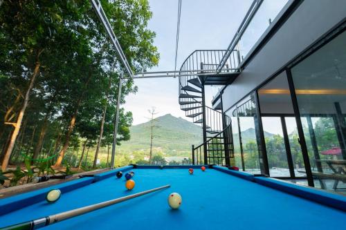 a pool table in front of a building at Cung Mây Villas - Venue Travel in Ba Vì