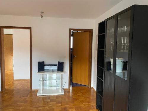 a living room with a black cabinet and a table at Ferienwohnung am Marktplatz in Weinheim