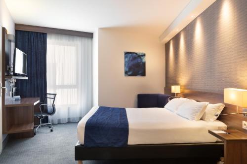 a hotel room with a bed and a desk at Holiday Inn Express - Marseille Airport, an IHG Hotel in Vitrolles