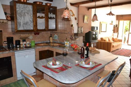 a kitchen with a table with glasses of wine at The Flowers' House in Potenza