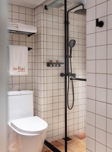 a bathroom with a toilet and a shower at the Figo in Hong Kong