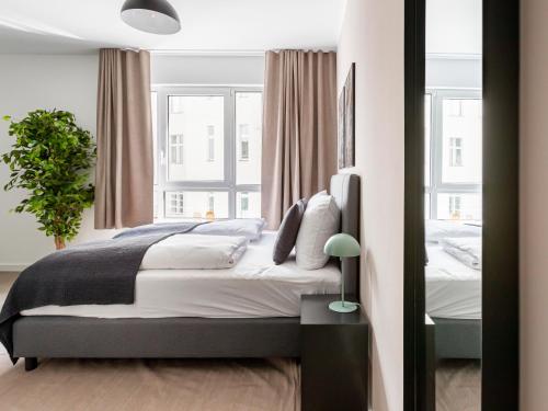 a bedroom with a large bed and a window at Limehome Berlin Luise Henriette Str - Digital Access in Berlin