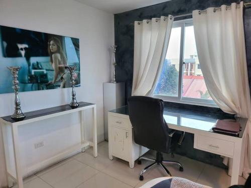 escritorio y silla en una habitación con ventana en Spacious 2 bedroom. Home comfort + hotel amenities, en Ángeles