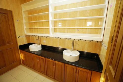 een badkamer met twee wastafels op een zwart aanrecht bij Luxurious & Comfy Retreat-Swimming Pool-Sauna in Angeles