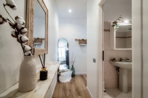 a bathroom with a sink and a mirror at Il Nido Tra Le Mura - by MyHomeInComo in Como