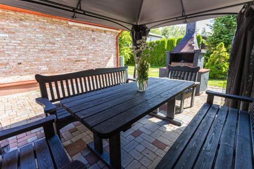 a picnic table with two benches and a grill at Schneider hause in Jūrmala