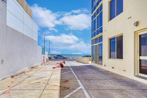 a sidewalk with orange cones on the side of a building at Beach apartment 10/22 esplanade sea-views in Glenelg