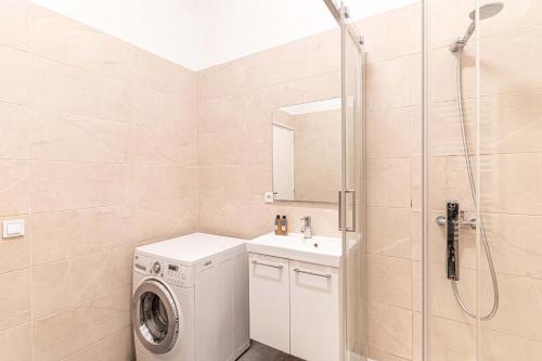 ein Bad mit einer Waschmaschine und einer Dusche in der Unterkunft 08 Design Flat Republique in Paris