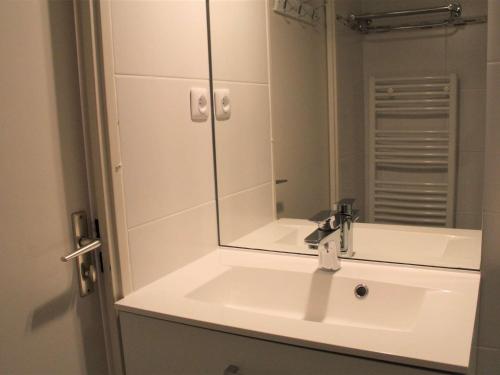 a bathroom with a sink and a mirror at Appartement Vars, 1 pièce, 6 personnes - FR-1-330B-138 in Vars