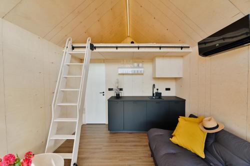 a room with a loft bed and a kitchen at Unique Tiny House at Saaremaa Golf & Country Club in Kuressaare