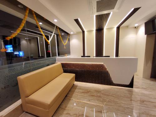 a lobby with a couch and a bar at Kings Palace in Chennai