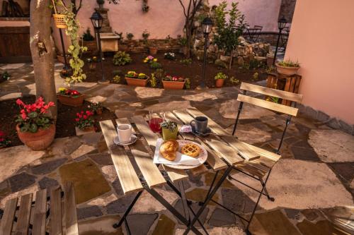 a wooden table with a plate of food on it at Il Rifugio dei Minatori in Iglesias