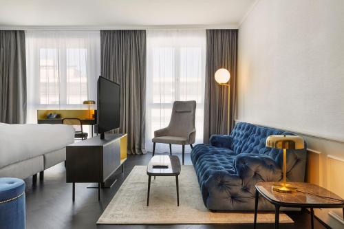 a hotel room with a couch and a bed at HYPERION Hotel Salzburg in Salzburg