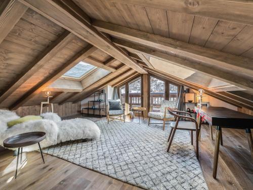 an attic bedroom with a bed and a piano at Chalet Méribel, 6 pièces, 10 personnes - FR-1-566-14 in Les Allues