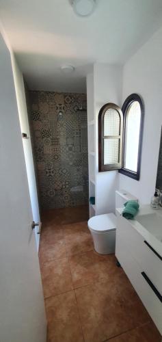 a bathroom with a toilet and a sink at Casa mediterránea Miami Playa in Miami Platja