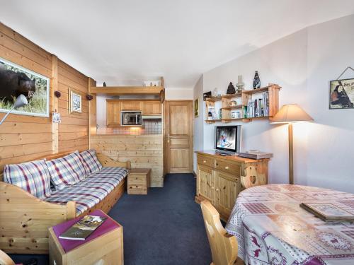 a living room with a couch and a bed at Appartement Courchevel 1650, 2 pièces, 4 personnes - FR-1-563-82 in Courchevel