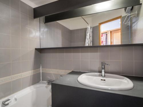 a bathroom with a sink and a bath tub at Appartement Courchevel 1650, 2 pièces, 4 personnes - FR-1-563-82 in Courchevel