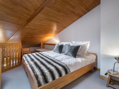 a bedroom with a large bed with a wooden ceiling at Studio Courchevel 1650, 1 pièce, 5 personnes - FR-1-563-91 in Courchevel
