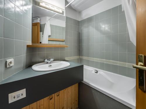 a bathroom with a sink and a bath tub at Studio Courchevel 1650, 1 pièce, 5 personnes - FR-1-563-91 in Courchevel