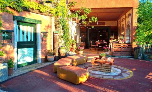an outdoor patio with a couch and a table at Krasberry Ježev brlog in Komen