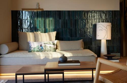 a bedroom with a bed and a table with a coffee table sidx sidx at Epiphany Villas Lefkada in Tsoukaladhes