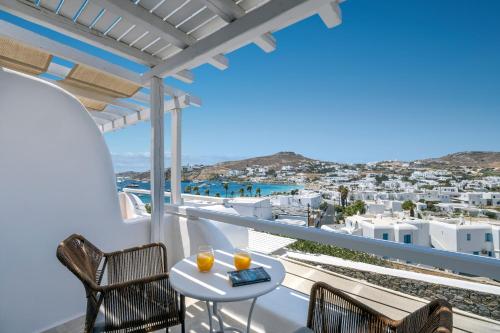 a balcony with a table and chairs and a view at Deliades Hotel in Ornos