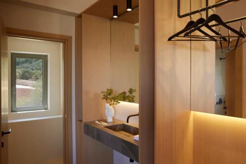 a bathroom with a sink and a mirror at Epiphany Villas Lefkada in Tsoukaladhes