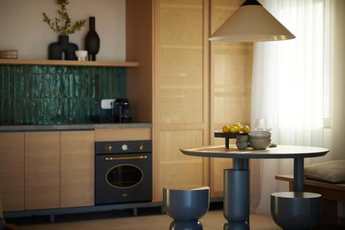 a kitchen with a table and a table with a dishwasher at Epiphany Villas Lefkada in Tsoukaladhes